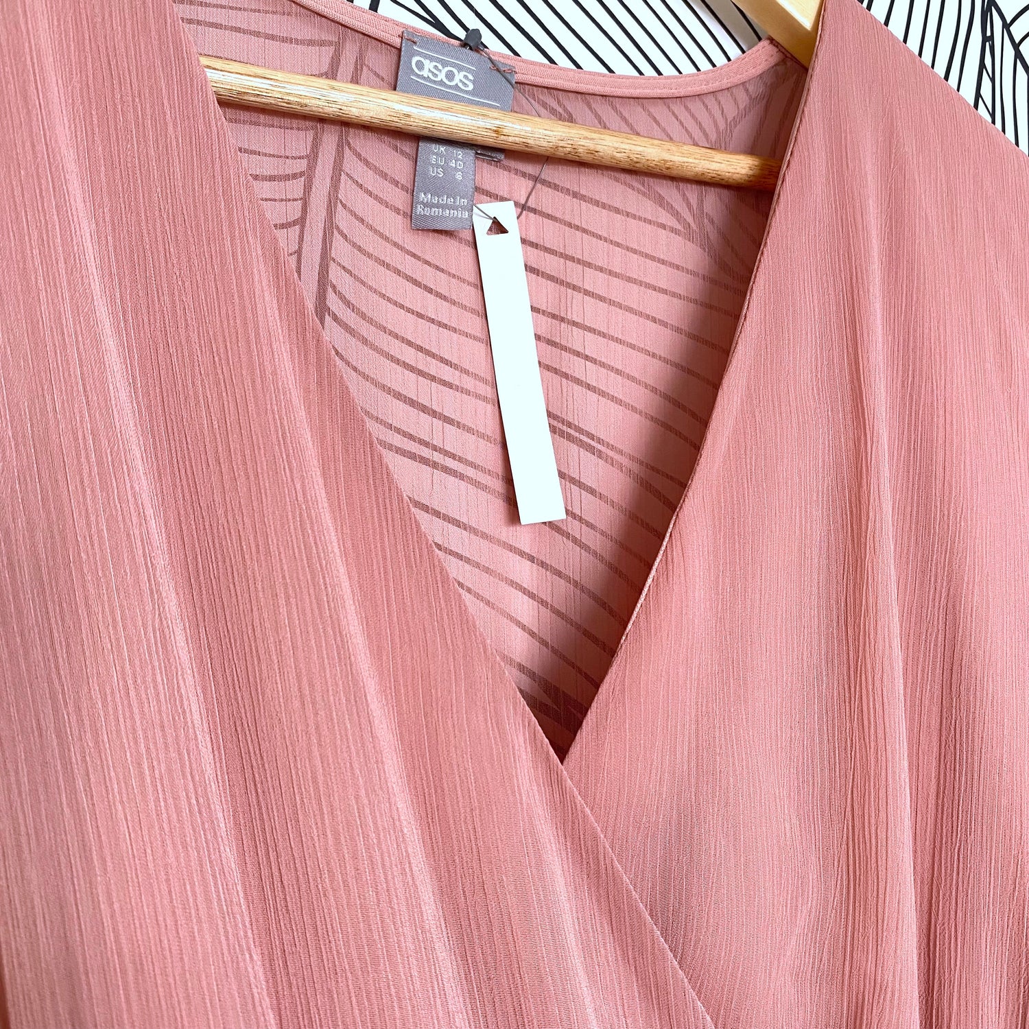 ASOS label of a pink dress showing that it is a size medium