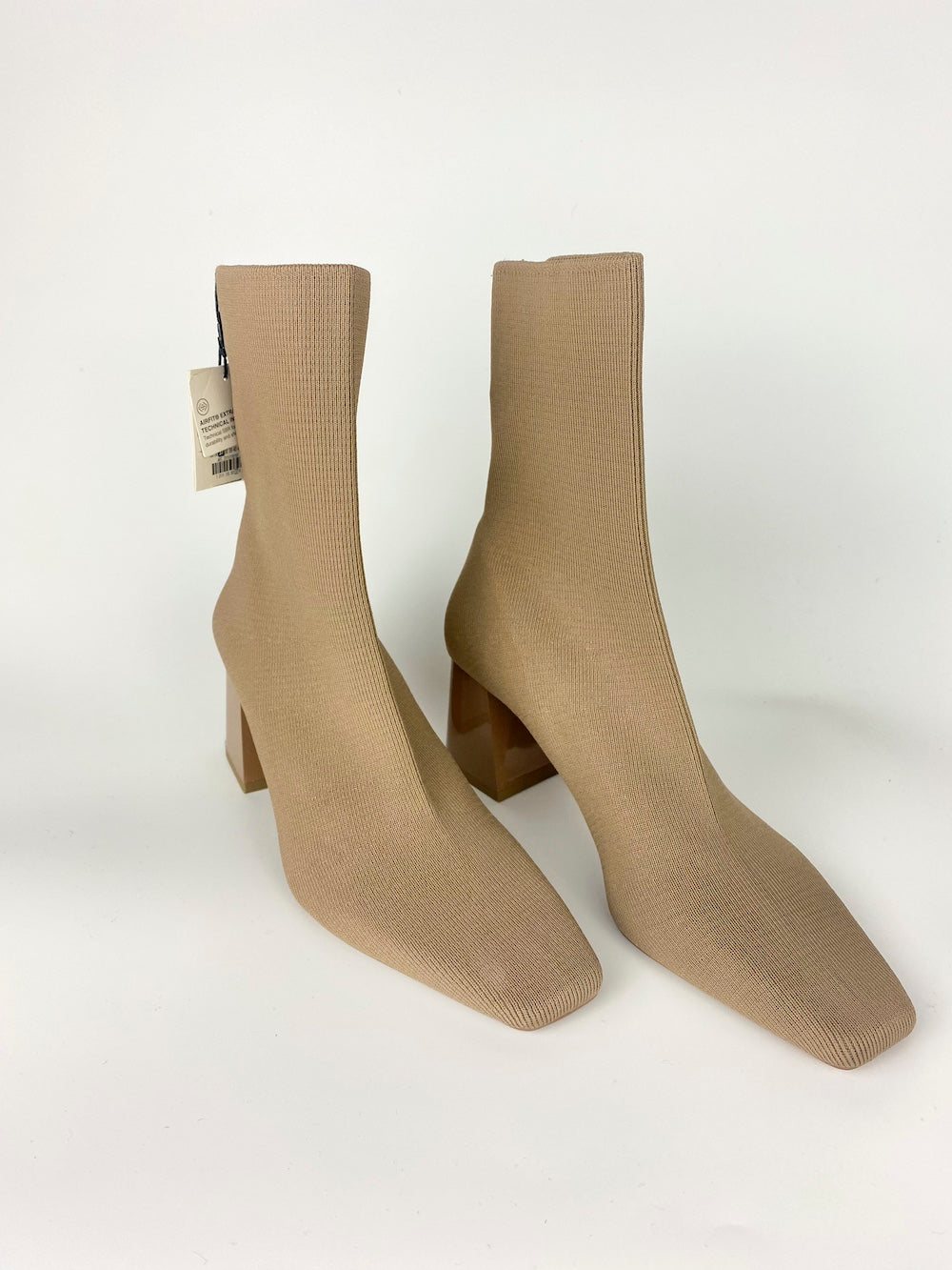 Womens ribbed cream heeled ankle boots on a white background