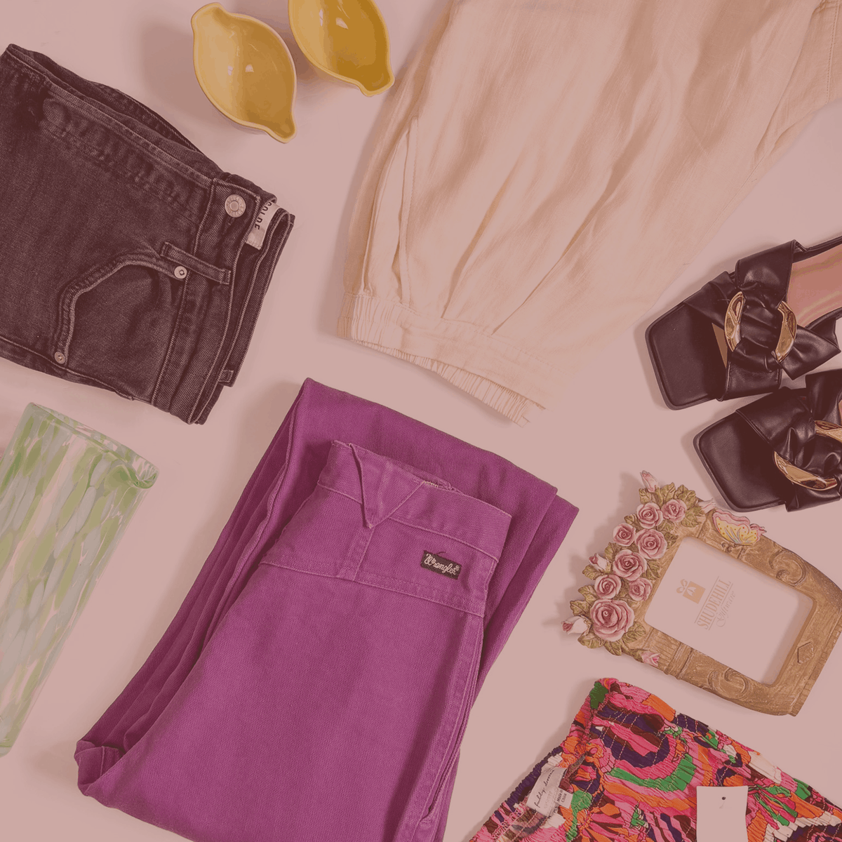 Purple pants, black shoes, and other items on a light surface