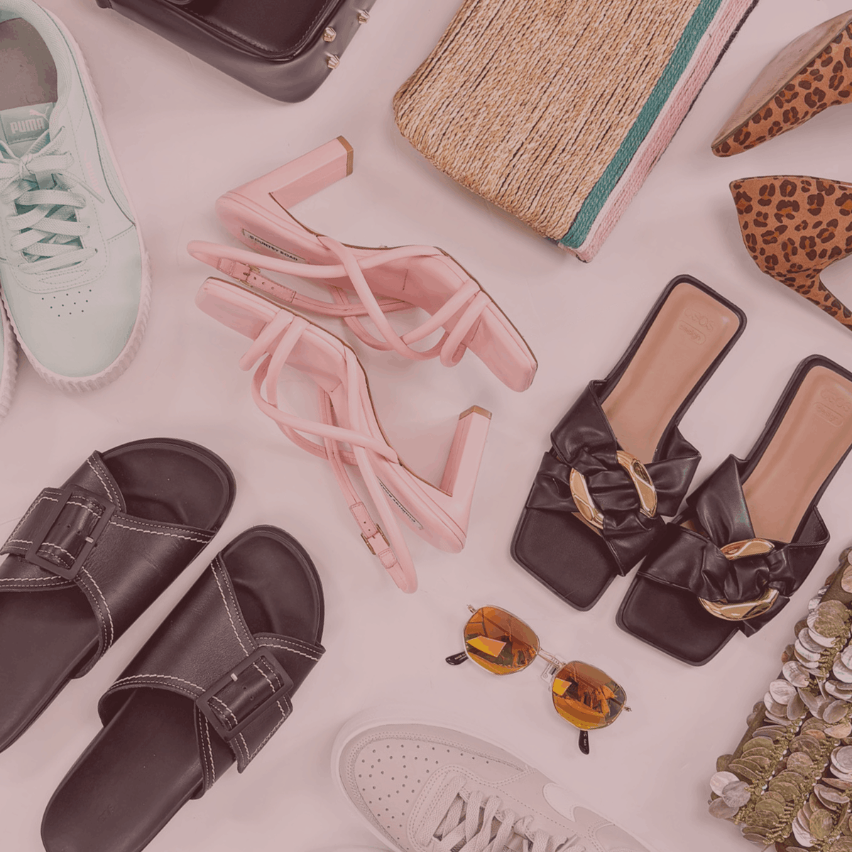Collection of shoes and accessories including sandals, high heels, and sunglasses on a light background