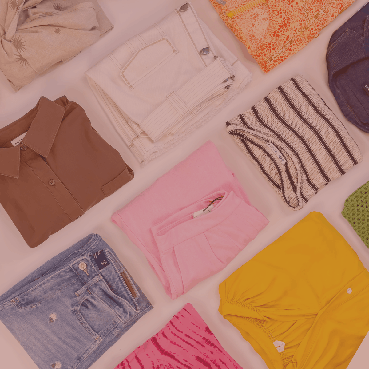 Assorted clothing items including shirts, pants, and shorts on a white background