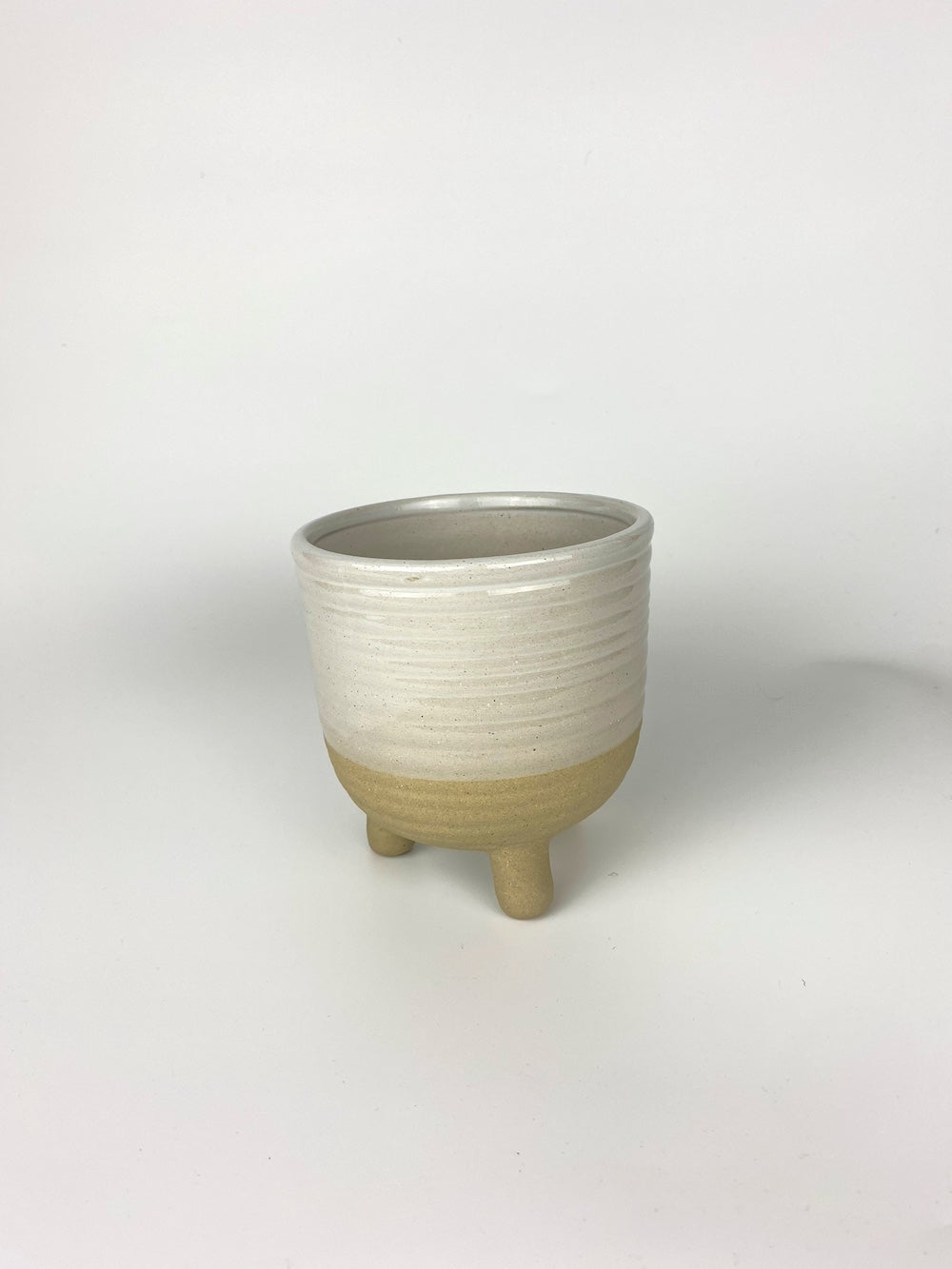 Cream ceramic plant pot on a white background